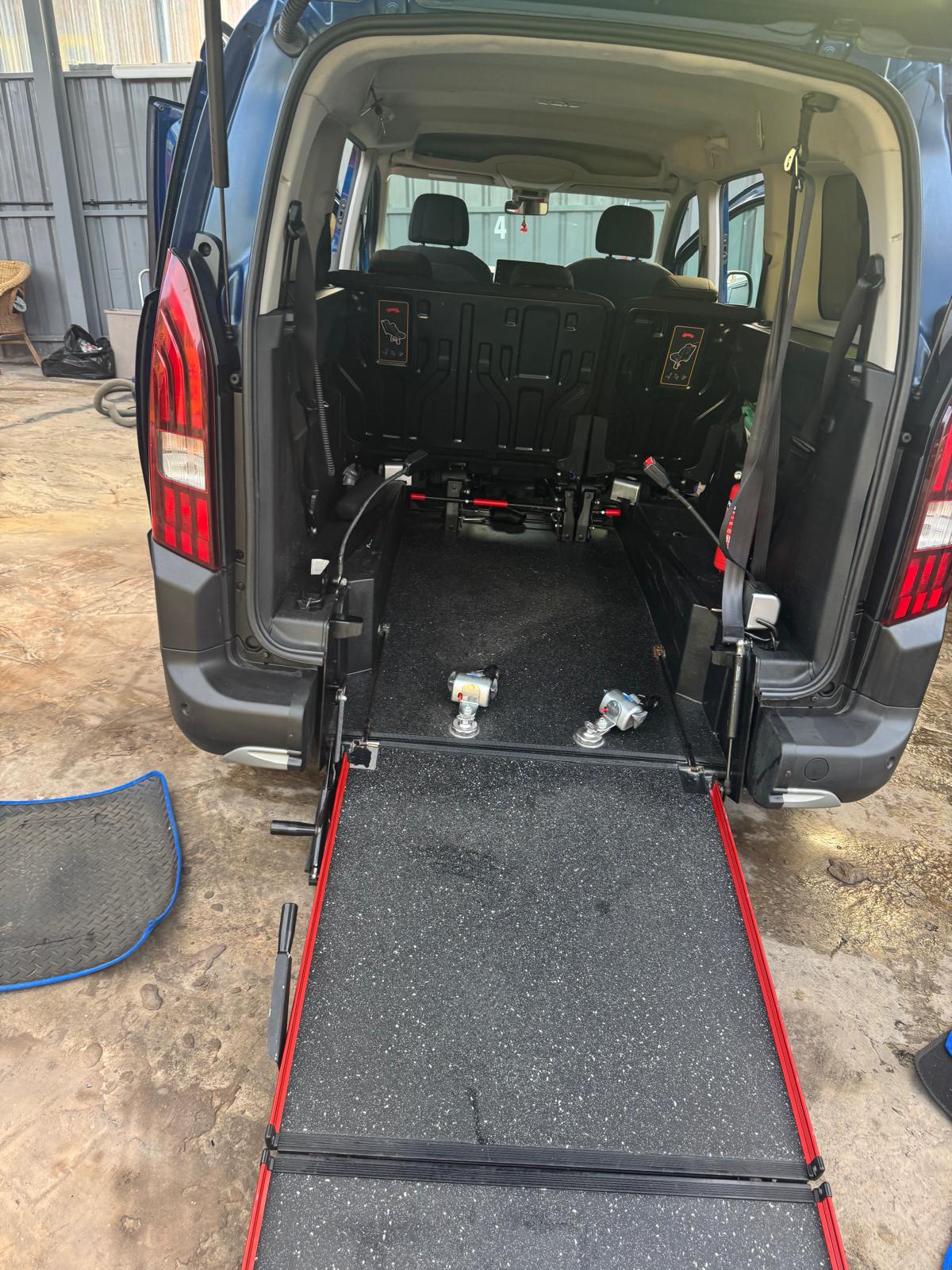 AV Cars wheelchair accessible vehicle with the rear ramp lowered and wheelchair restraints fitted